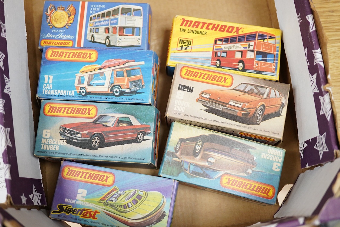 Twelve boxed Matchbox Superfast and Rola-matics 1-75 vehicles; rescue hovercraft (2), Porsche turbo (3), Mercedes tourer (6), Rover 3500 (8), car transporter (11), the Londoner bus (17), Silver Jubilee bus, cement truck